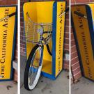 Bicycle with rack incorporated into California Aggie news stand