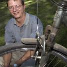 photo: portrait of man behind dusty bicycle