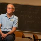 Professor Richard Scalettar, seated in front of blackboard