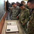 ROTC cadets look at the Golden Memory Book.