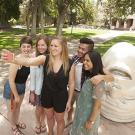 Five students  take a selfie with one of the iconic Eggheads at UC Davis