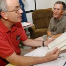 Professors Walt Stone, left, and Bob Huckfeldt talk about events that give rise to political partisanship as they turn through the pages of Huckfeldts new book, Political Disagreement: The Survival of Diverse Opinions Within Communication Netwo