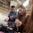 Three students in a lab working on coffee making