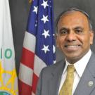 Man with flags in background