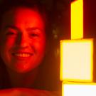 Sydney Patterson with her child-friendly lighting design photographed in a red light 