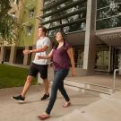 Two students walking in front of new Cottonwood Hall