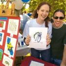 Bethany Daniels and Richard Sutherland of communication resources show off the winning TGFS logo design for next year, created by Holly Guenther of insurance services.