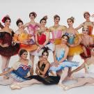 Photo: Cast of Les Ballets Trockadero, in colorful ballet costumes.
