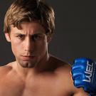 Urijah Faber sparring in boxing gloves facing the camera