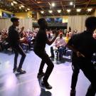 Four men give a step dance performance.
