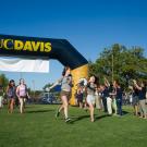 Photo: New students pass under the UC Davis arch.