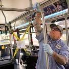 A worker disinfects a Unitrans bus.