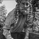 Black and white photo of farm worker in field, part of Library exhibition