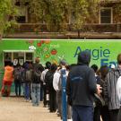 Students queue up for the bright green Aggie Eats food truck