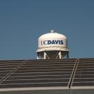 solar panels in foreground with /uC Davis water tower in background