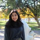 Donia Ghaith smiling in front of Mrak Hall on a sunny day.