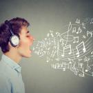A man wearing headphones sings. White sketches of musical notes trail out of his mouth.