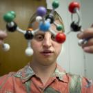 A student holds a molecular model