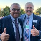 Ashish Jha, White House official, and Richard Coris, UC Davis faculty, both giving thumbs-up outside the White House