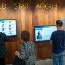 People look at Gold Star Aggies Wall in Memorial Union