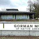 A white museum sign that reads "Gorman Museum of Native American Art" is pictured in front of the renovated museum.