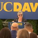 Vice Chancellor Kelly Ratliff at podium, "UC Davis" banner behind her