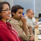 Students are seen from the side as they pay attention in class