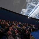 People watch a film in a planetarium. 