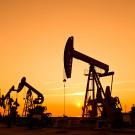 Oil wells in sunset.