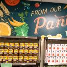 "The Pantry" sign in script, above shelves filled with canned food