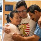 parents embrace student at move in day