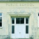Front of public school with label above doors.