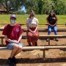 Five students, masked and socially distanced, seated outside.