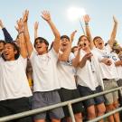Students cheer at a football game.
