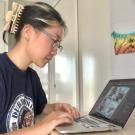 Lauren Hong at work at her virtual internship on her laptop. 