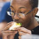 A young man eating a sandwich