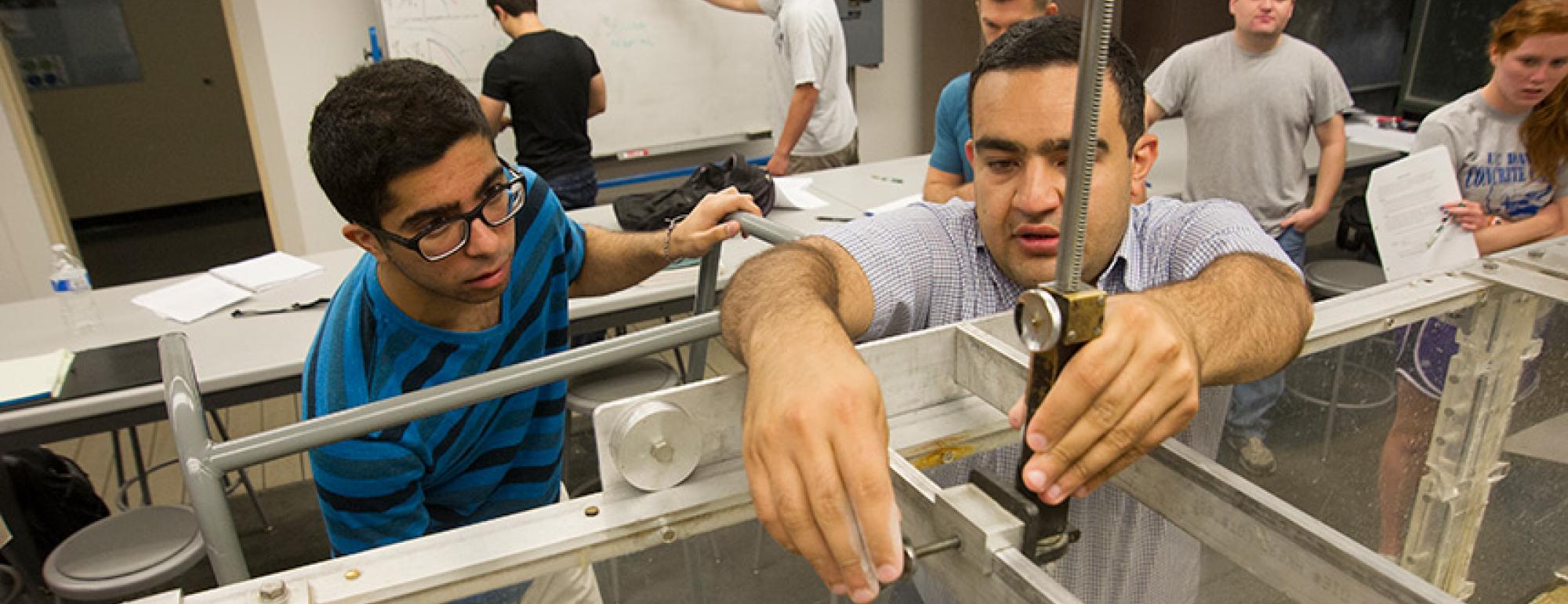 UC Davis civil and environmental engineering graduate student Kaveh Zamani, right, showing a student how to use an instrument
