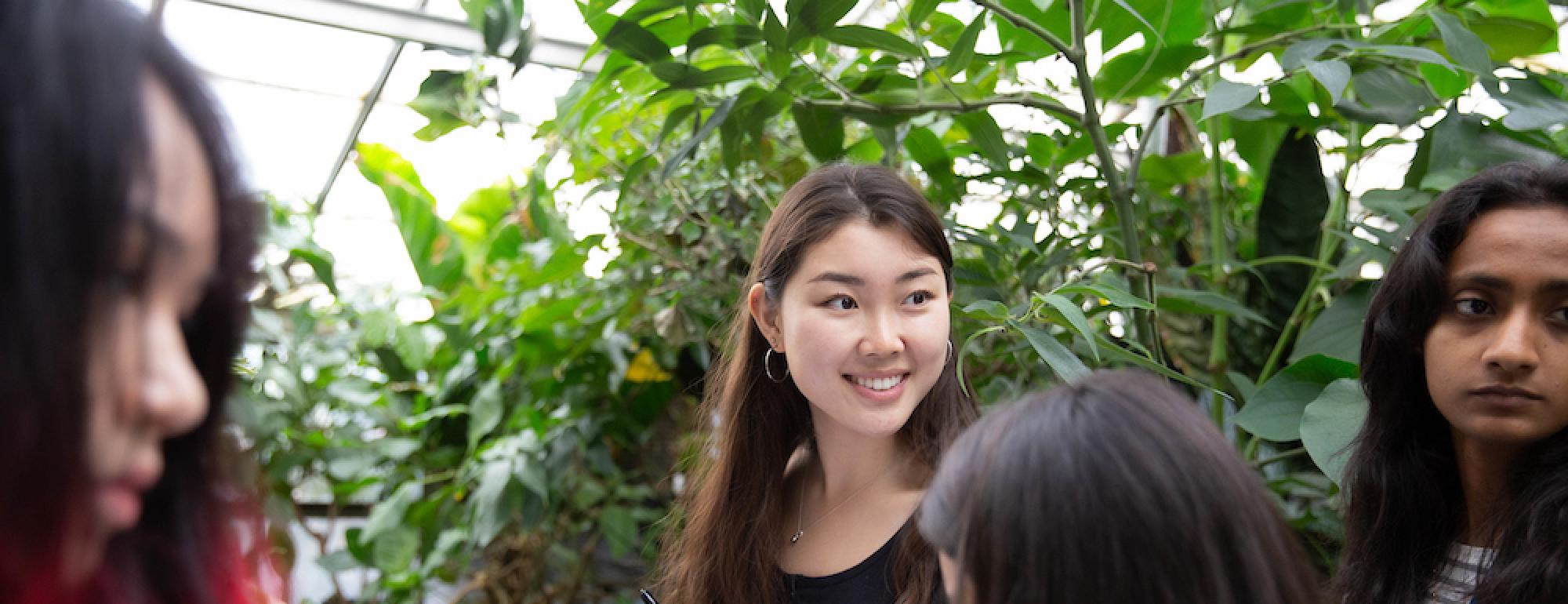 Students smile in a botanical garden at UC Davis. 