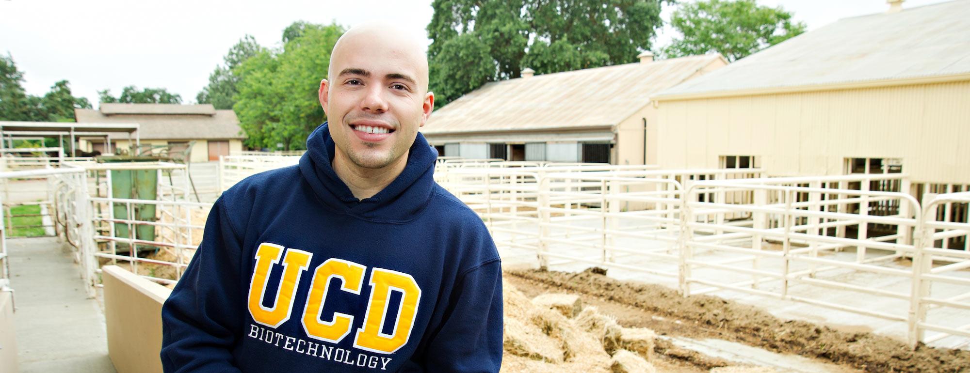 A male student poses at the UC Davis dairy