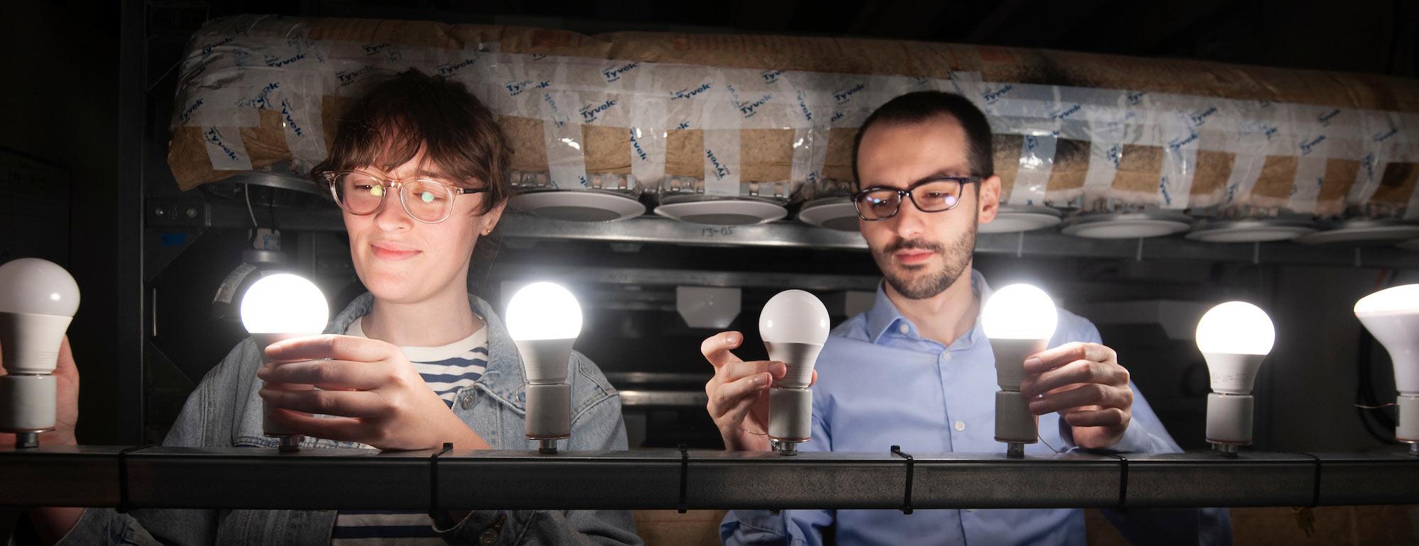 Two students adjusting several LED lights