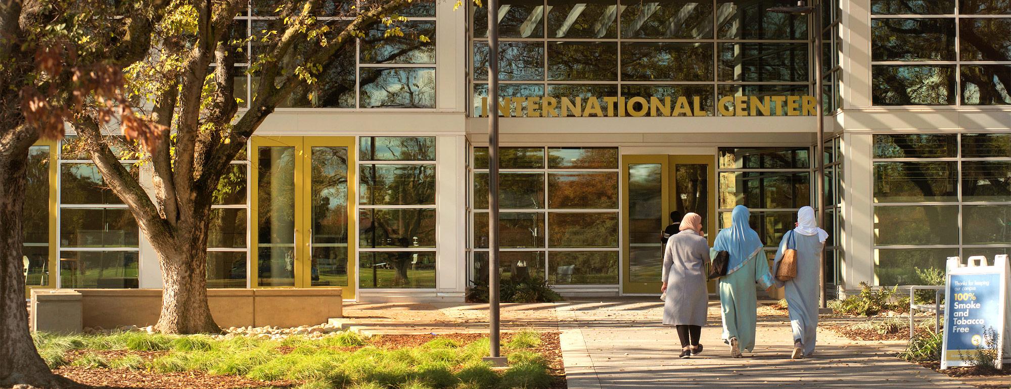three international students entering the international center on campus