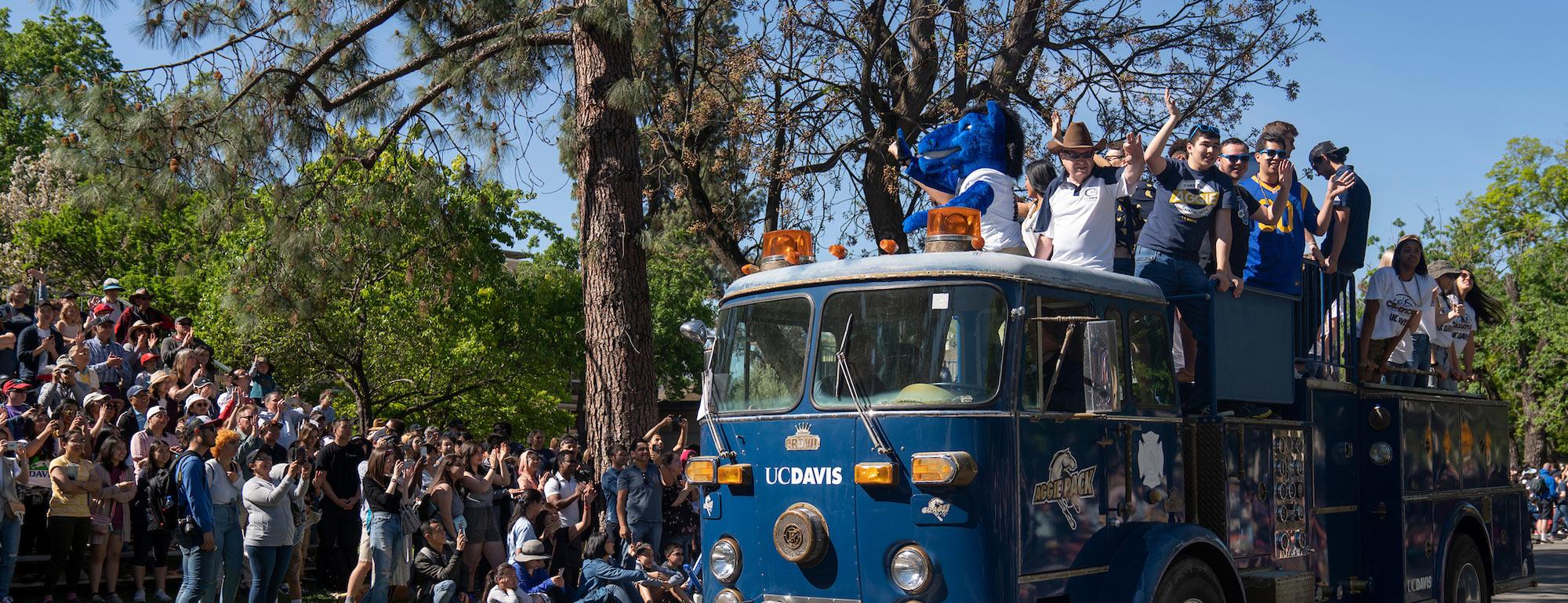 Our custom UC Davis fire engine carrying some of our student athletes during the Annual Picnic Day parade