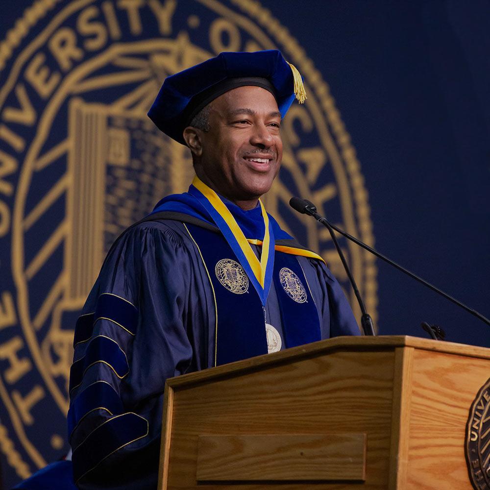 Chancellor May delivers a commencement speech wearing full academic regalia