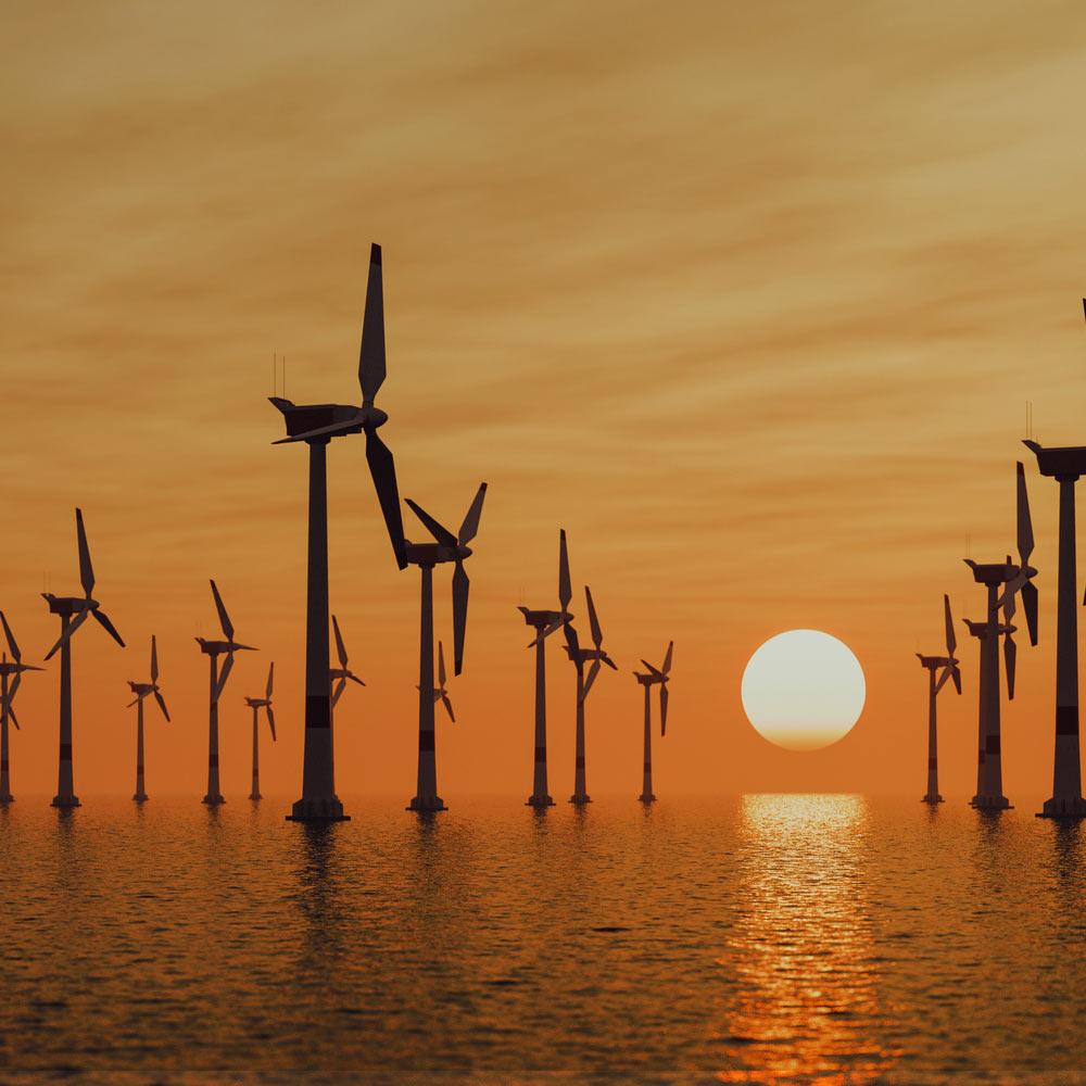 Offshore windmills at sunset