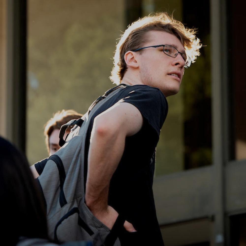A male student looks back over his shoulder