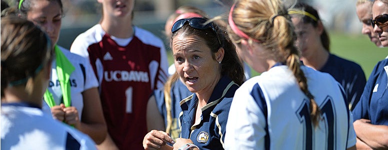Soccer coach Twila Kaufman talking to her team of female players