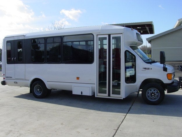 A white shuttle bus parked