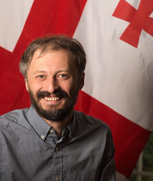 Kakhaber Bakhtadze portrait in front of the Georgian flag