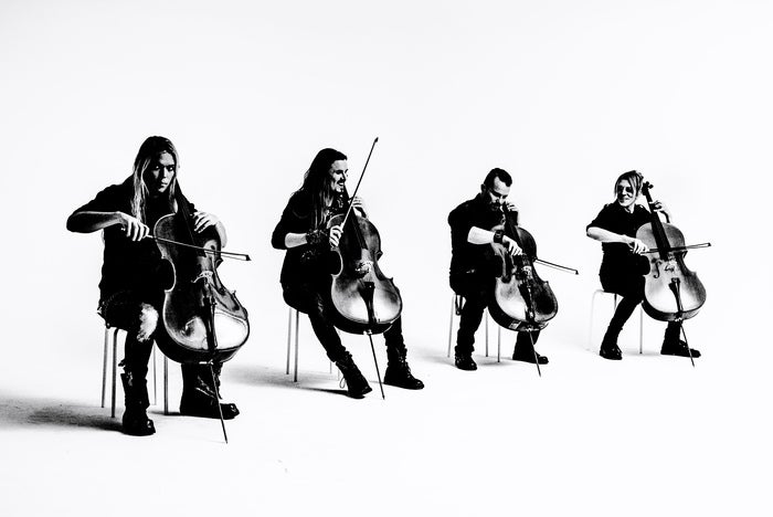 The four cellists of Apocalypta playing in front of a white background.