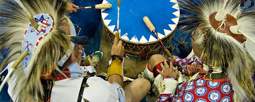 Native Americans beat a drum at the annual Powwow